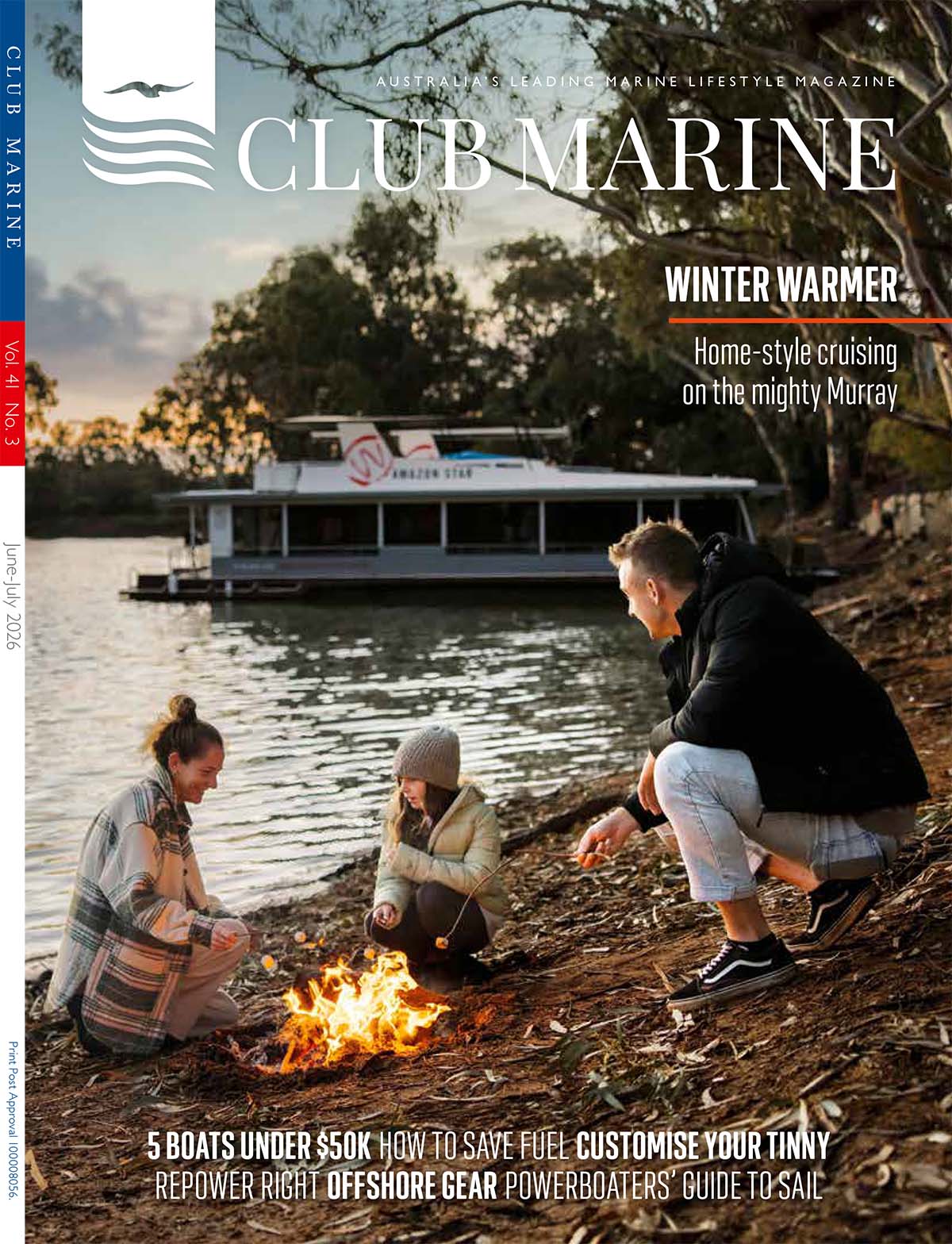 Image of Club Marine Magazine front cover with a family sitting on lake edge around campfire with houseboat in background