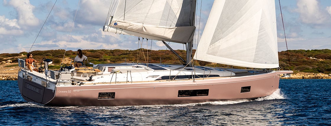 Beneteau Oceanis 52 yacht sailing with a man and woman on the back