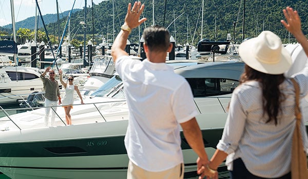 Man and woman waving to friends at d'Albora Marina