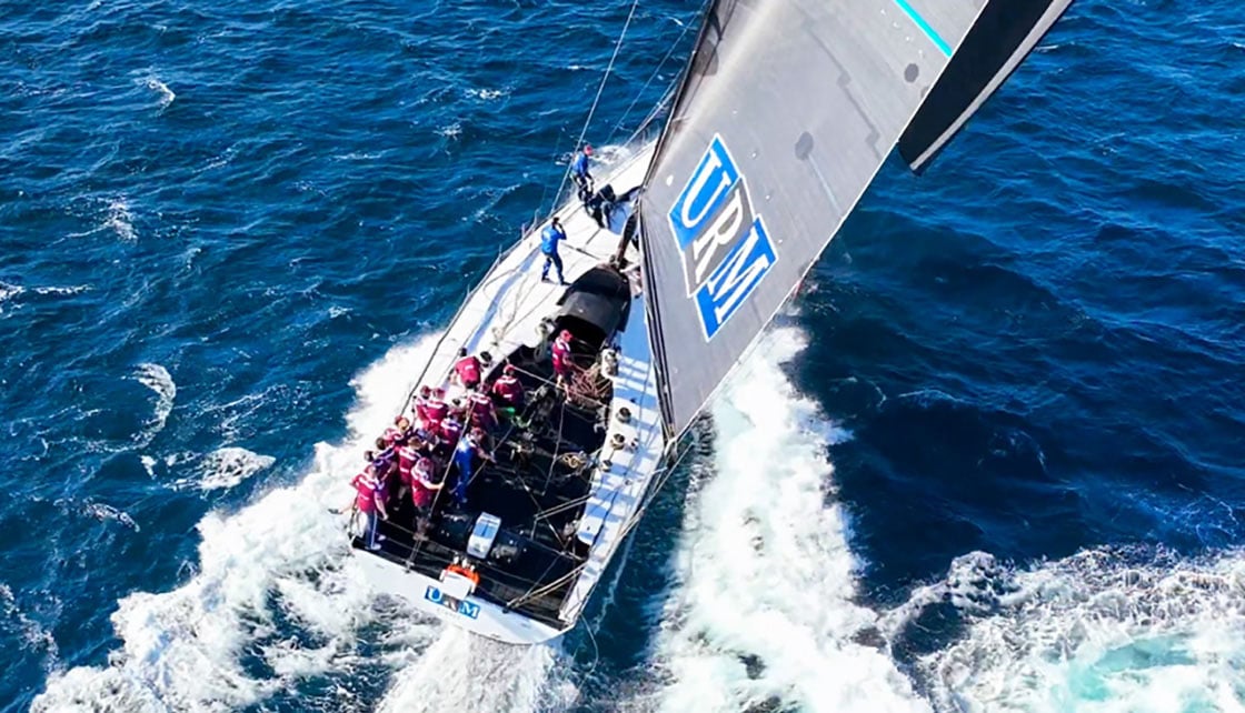 Yacht and crew sailing in ocean