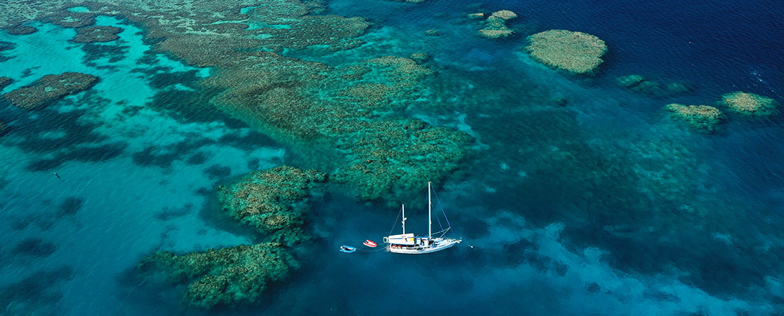 Great Barrier Reef Marine Park Yacht moored next to reef