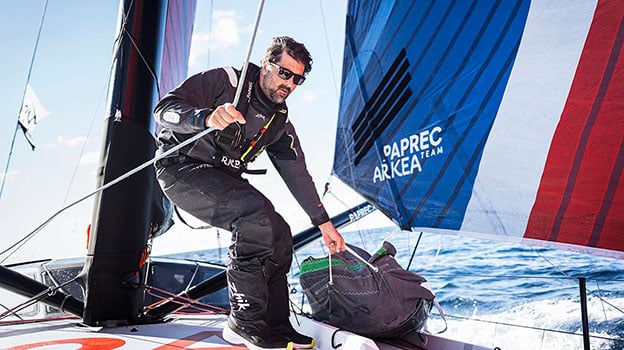 Man sailing boat in wet weather gear