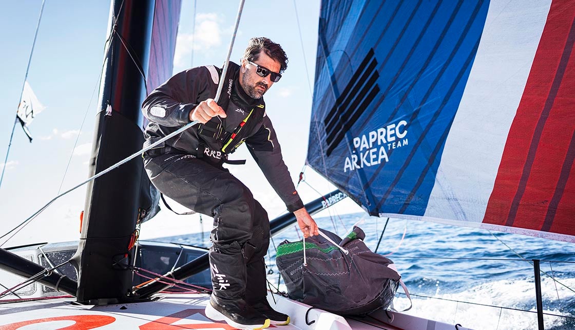 Man sailing on yacht in wet weather gear