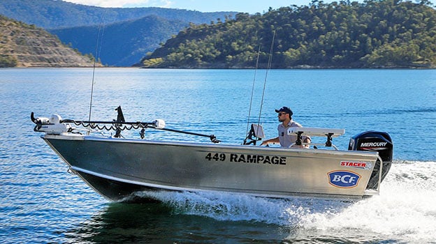 Man driving tinny across lake