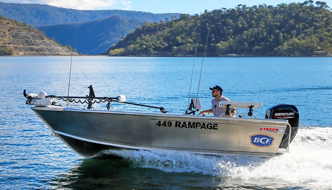 Man driving tinnie across lake