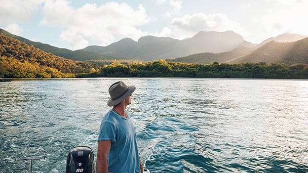 Man on boat looking out at lake on Hinchinbrook Island, Australia