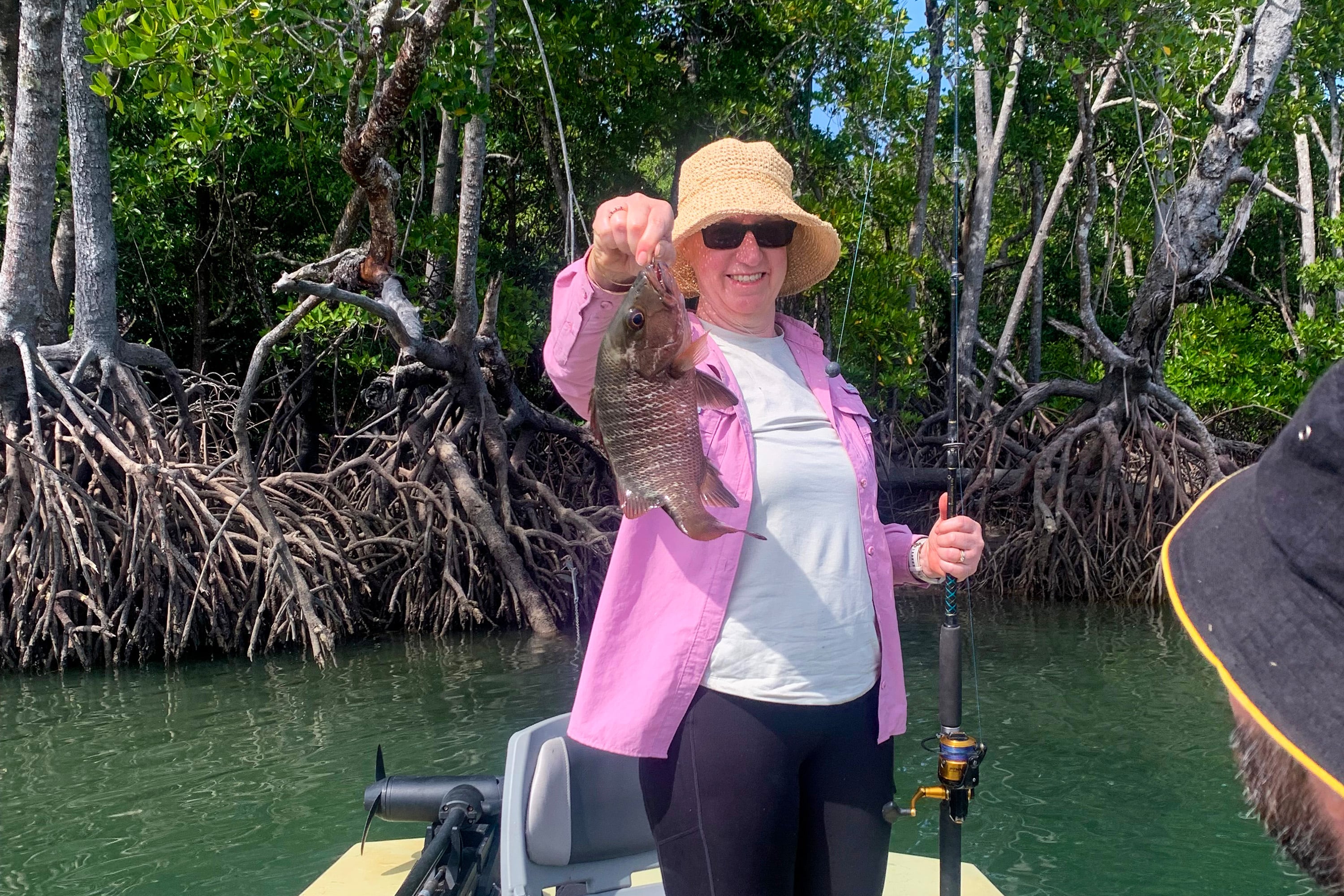 Woman holding a mangrove jack