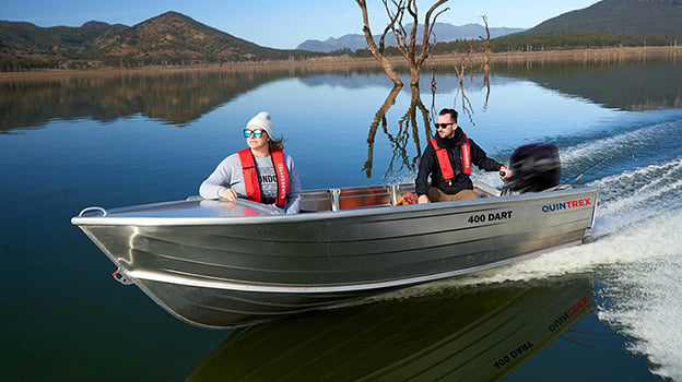 Man and woman riding in a tinnie on a lake