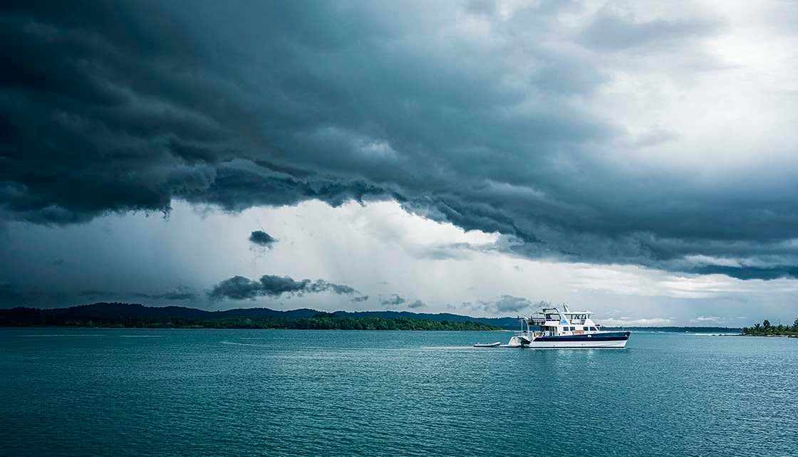 Dark clouds above boat at sea