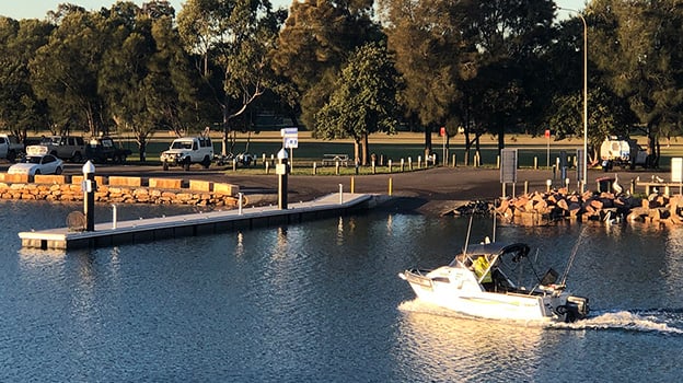 Fishing boat motoring back to boat ramp