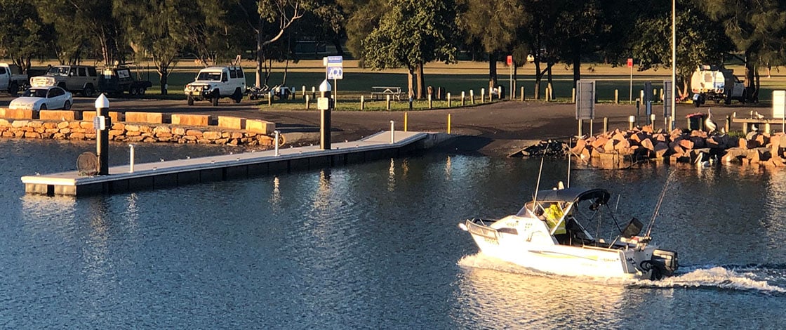 Runabout motoring at boat ramp