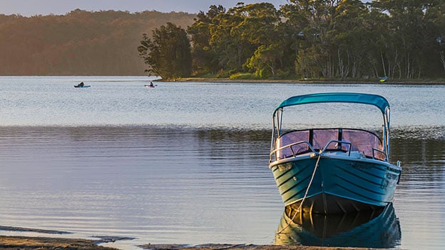 Fishing boat tied up on lake shore in Australia