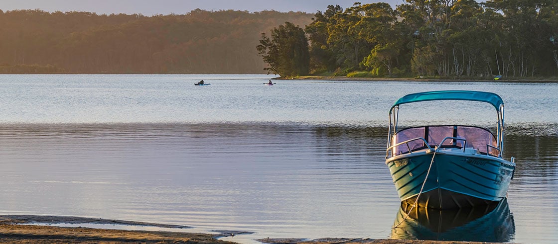 Fishing boat tied up on lake shore in Australia